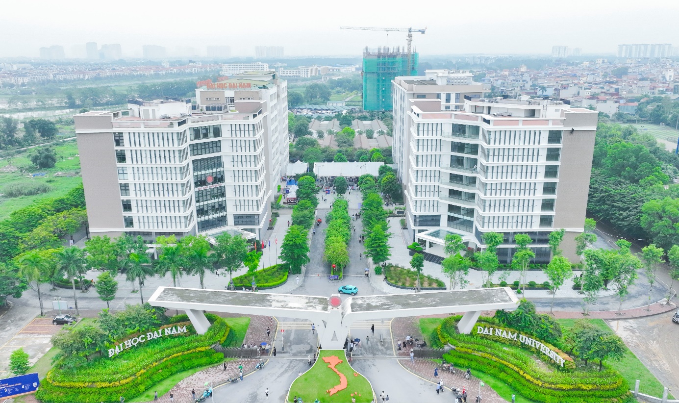 A group of buildings with trees and a road Description automatically generated with medium confidence